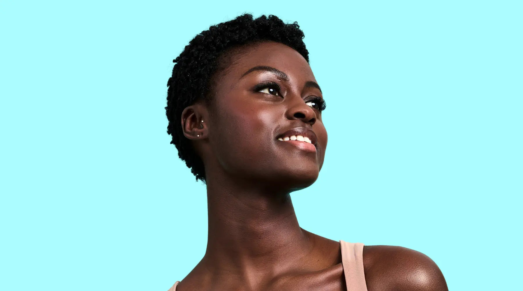 woman looking away in front of a light blue background